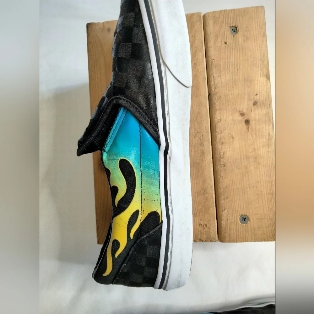 Vans slip on shoe. Size 7. Black  with blue/green and yellow🔥 running down side